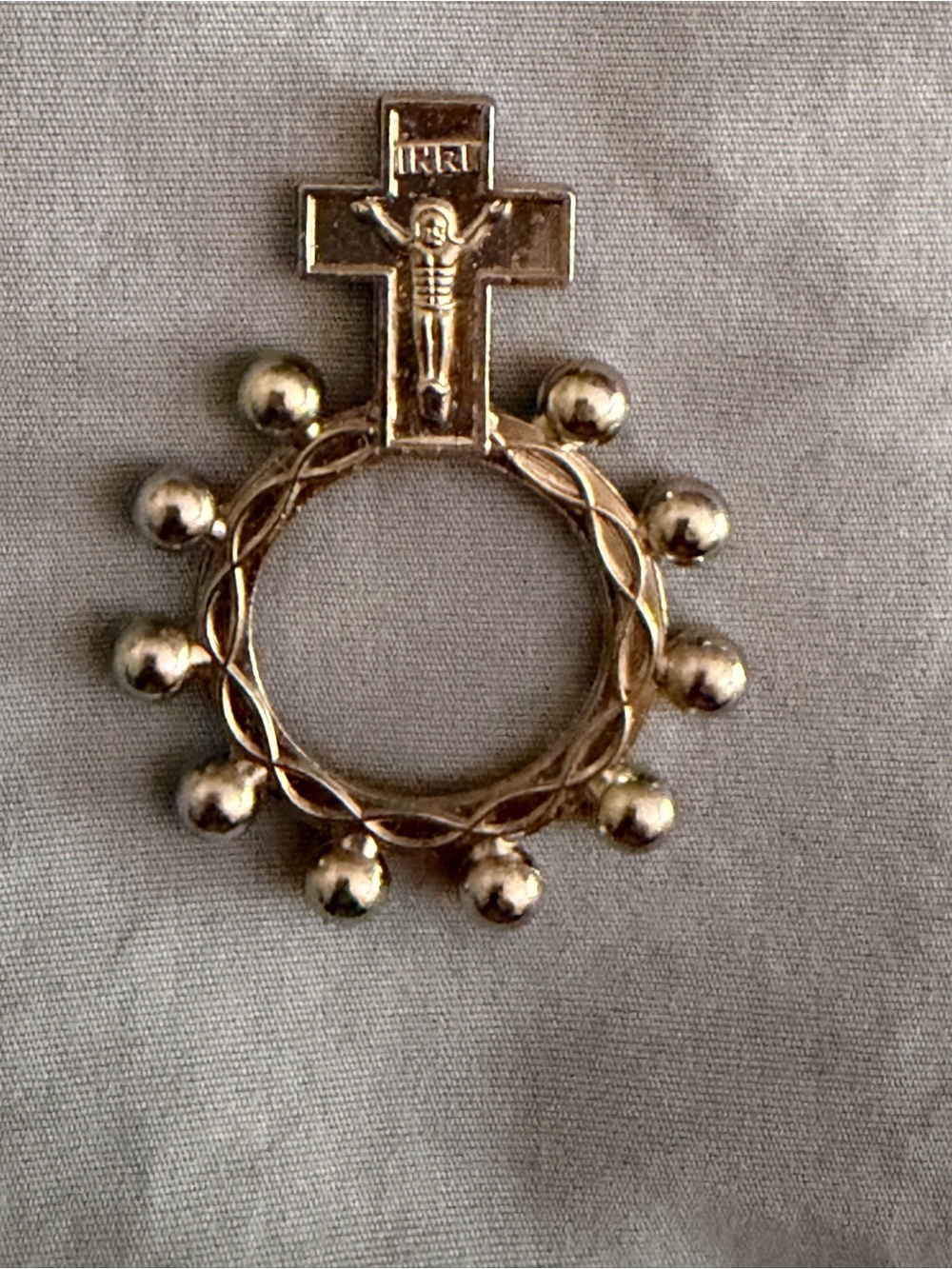 Silver tone single-decade finger rosary ring designed for portable prayer.